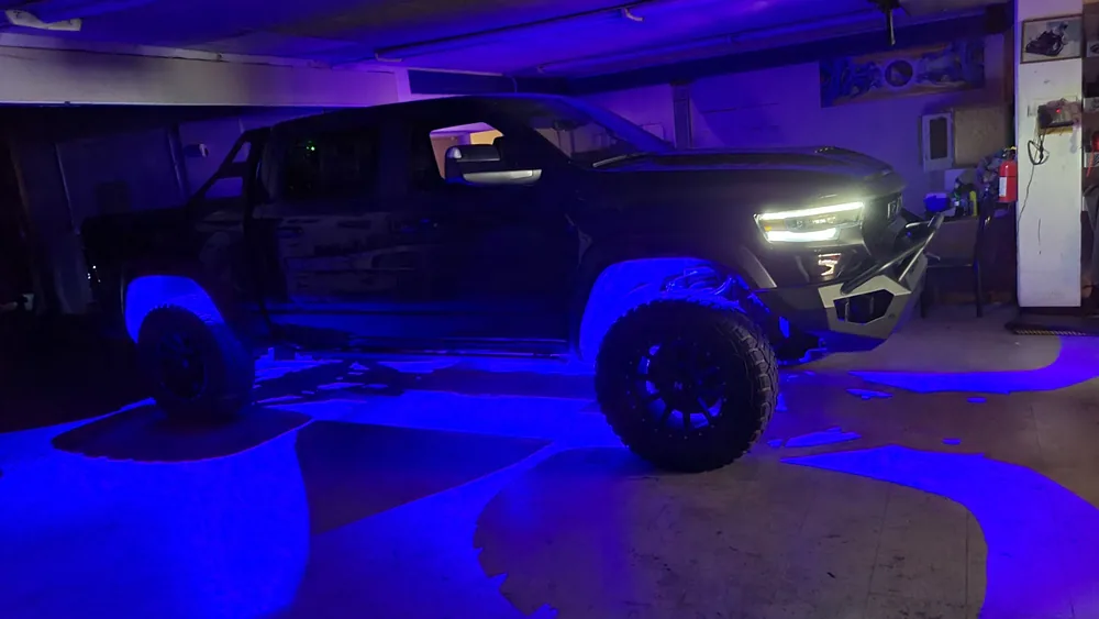 Truck with blue underglow lighting at night